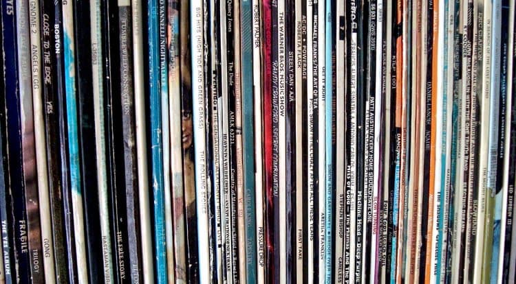 Rows of vinyl records standing on edge in crates