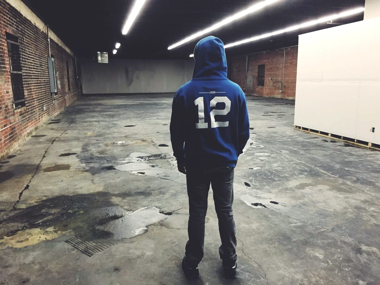 A gutted brick warehouse stands empty with bare concrete floors.